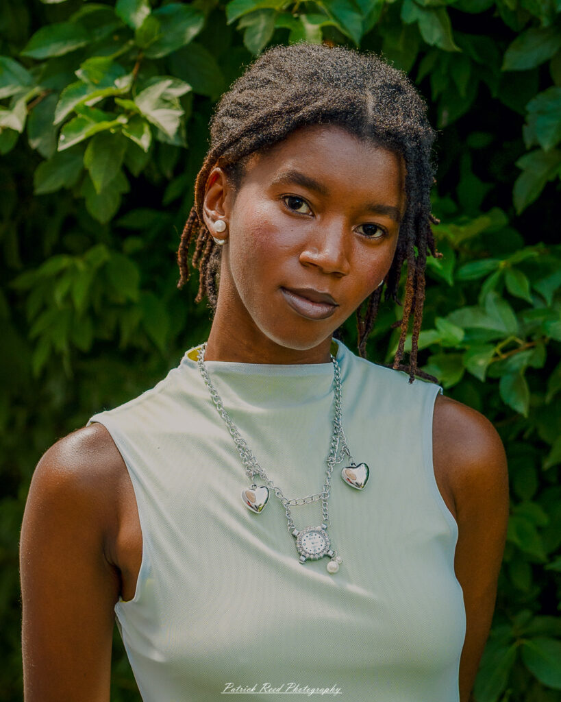 Natural light portrait of a model, photographed on June 28, 2025. She is posed outdoors with soft, flattering lighting, conveying a calm and confident expression.